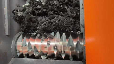 Close-up of shredder blades rotating to grind material Stock Footage 346812963