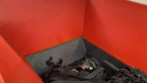 Close-up of a shredder machine rotating to grind synthetic carpet scrap Stock Footage 346812980