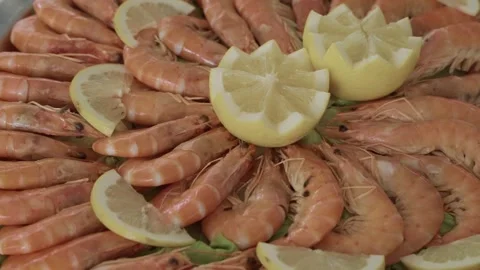 Close up of shrimp platter garnished with lemon slices at seafood buffet Stock Footage 318591017