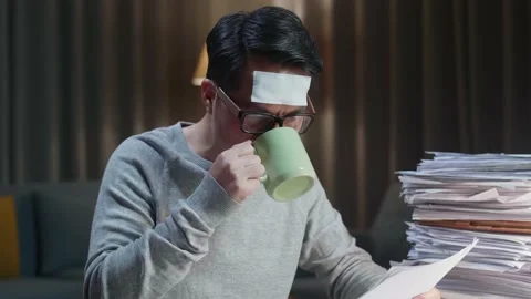 Close Up Of Sick Asian Man Drinking Water While Working Hard With Documents Stock Footage 196928986