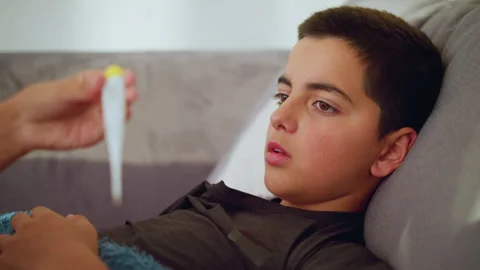 Close Up of Sick Boy Watching Thermomete... | Stock Video | Pond5