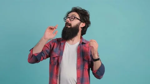 Close up of a sick man sneezing. Bearded man isolated on turquoise background. Stock Footage 142003048