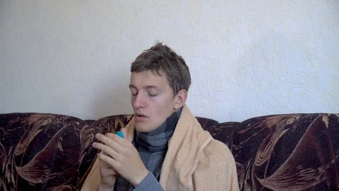 Close up sick man uses nasal spray for runny nose Stock Footage 118911325