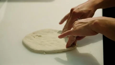 Close up side angle pizza dough being stretched slow motion Stock Footage 229808909