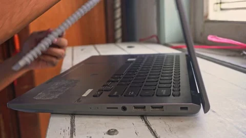 Close up side angle view of male worker closing laptop and holding spiral n.. Stock-Footage 345137266