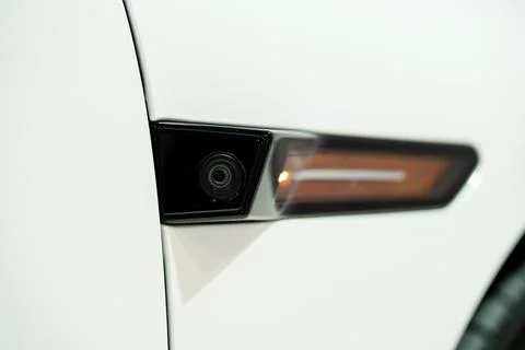 Close up of side camera and indicator on white car Stock Photos