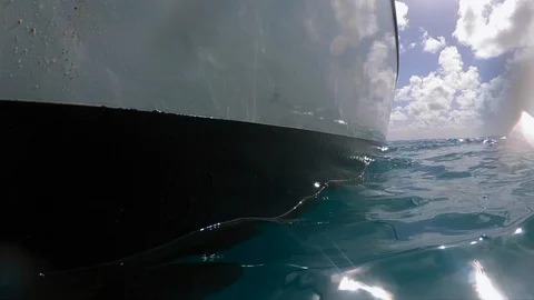 Close up of the side of a catamaran from the ocean water level Stock Footage 129389834