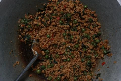 A close up of a side dish with stir-fried leunca and oncom 写真素材