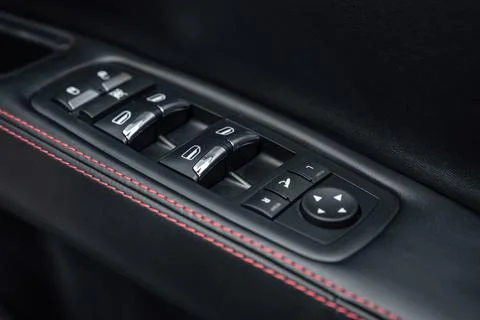 Close-up of the side door buttons: window adjustment buttons, door lock. Mirror 스톡 사진