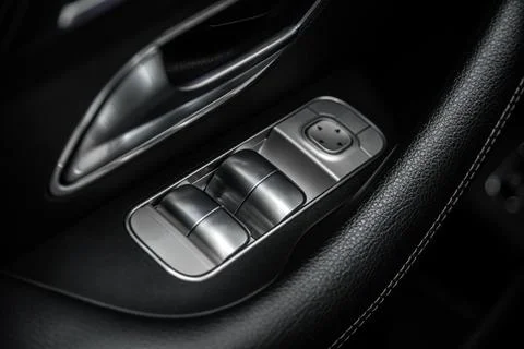 Close-up of the side door buttons: window adjustment buttons, door lock. Stock Photos