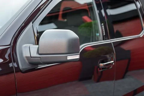 Close-up of the side left mirror and window of the car body black SUV on the  Stock Photos