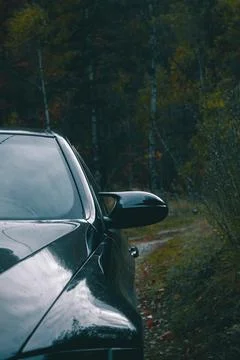Close up of the side mirror of a dark blue car. Stock Photos