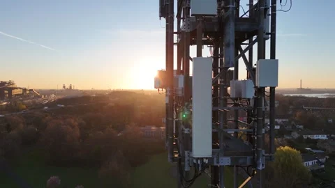 Close side pass of telecom mast at sunrise Stock Footage 341418186