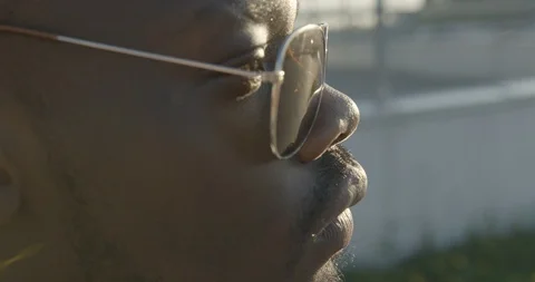 Close-up side portrait of the young attractive african man in modern sunglasses Stock Footage 89580246