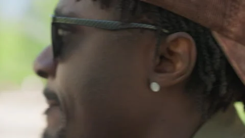 Close up side profile view of bearded man wearing sunglasses ear protection and Stock Footage 345123630
