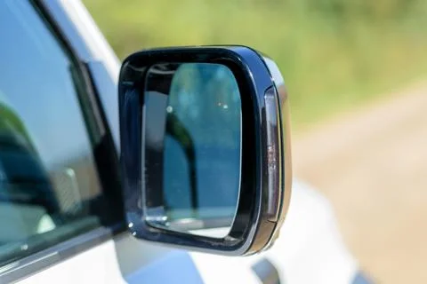 Close-up of the side right mirror and window of the car body white SUV. Exter Stock Photos