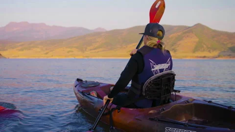 Close up side shot of blonde lady to full back shot of two ladies kayaking b Video stock 167803445
