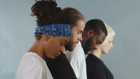 Close up side shot of group of people of different races raise head black white Stock Footage 133641159