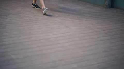 The close-up side shot of the new blue and white shoes of young girl walking Stock Footage 89968547