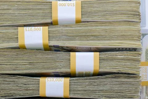 Close up side view of 4 straps of ten thousand one hundred US dollar bills 写真素材