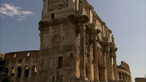 Close up of side view of Arch of Constantine with Colosseum behind Stock Footage 95603117