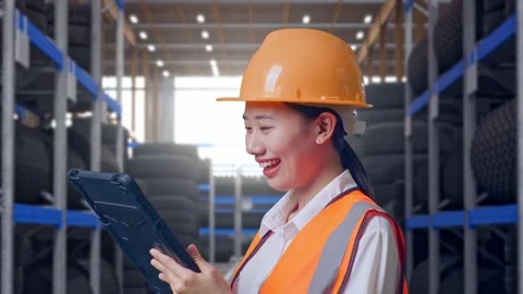 Close Up Side View Of Asian Female Engineer Working On A Tablet Tire Warehouse Stock Footage 341788711
