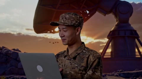 Close Up Of Side View Asian Man Soldier Using A Laptop With Satellite Dish Stock Footage 293335631