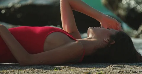 Close-up side view of the attractive girl enjoying the sunbathe while lying on Stock Footage 85457983