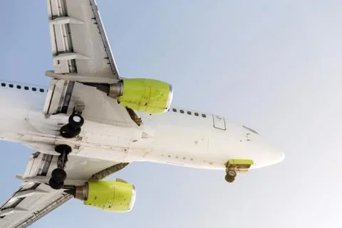 Close-up side view of big passenger airlplane flying against clear blue sky 스톡 사진