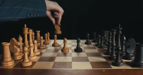 Close up side view of businessmen playing chess making moves with white and Stock Footage 136885998