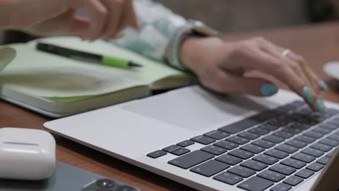 Close-up side view of a businesswoman's hands adeptly typing on a laptop Stock Footage 245259271