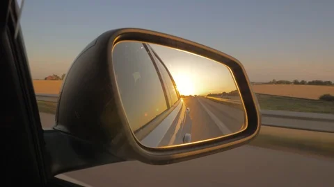 Close-up of the side view car mirror at sunset Stock Footage 108515372