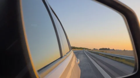 Close-up of the side view car mirror at sunset Video stock 108515413