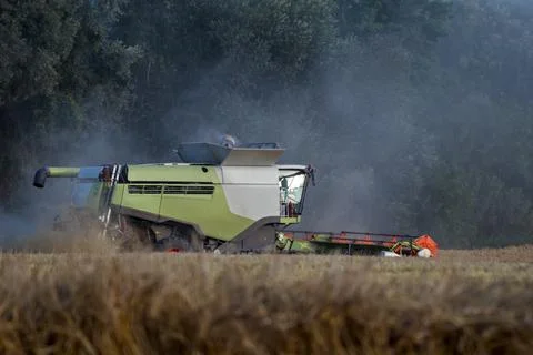 Close Up Side View of Combine Harvester Harvesting Crops Stock Photos