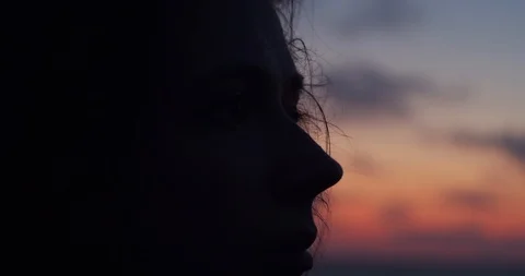 Close up side view of female face silhouetted by sunset evening light  Stock Footage 112758464