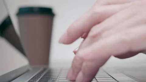 Close-up side view: female hands type on laptop keyboard Stock Footage 140424049