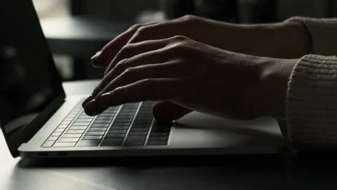 Close up side view of female hands typing on a laptop keyboard Stock Footage 237332152