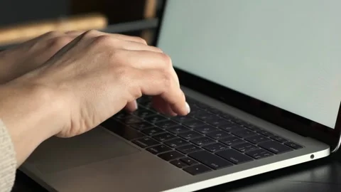 Close up side view of female hands typing on a laptop keyboard Video stock 238904485