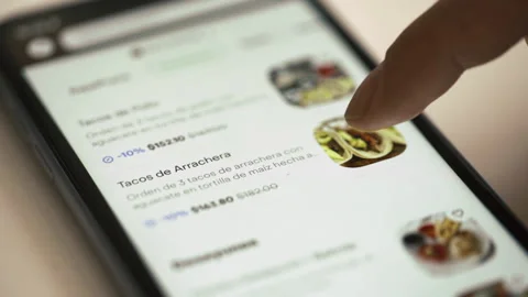 Close-up Side View Female Purchaser Looking Shopping List in Smart Phone Stock Footage 224488762