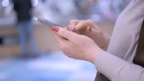 Close-up Side View Female Purchaser Looking Shopping List in Smart Phone Inside Stock Footage 265984010
