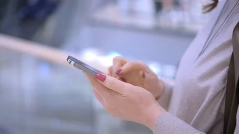 Close-up Side View Female Purchaser Looking Shopping List in Smart Phone Inside Stock Footage 266264729