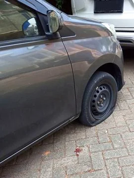 Close-up side view of flat car tire, punctured wheel Stock Photos