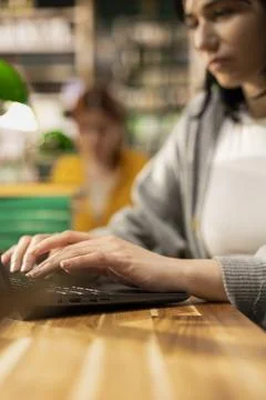 Close up side view of focused student typing on laptop and taking notes Stock Photos