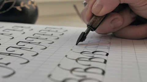Close side view follow shot of a fountain pen being held with a Hand writes Video stock 128269262