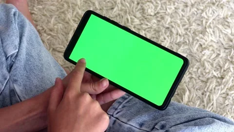 Close up side view girl smartphone looks at the green screen on the phone slowly Stock Footage 165291693