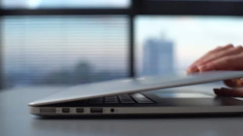 Close-up side view of hands of unrecognizable business woman opening laptop lid Stock Footage 153393084