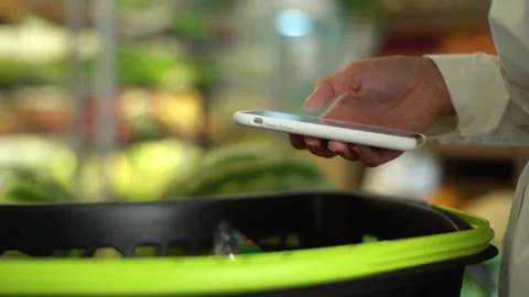 Close-up side view hands of unrecognizable young woman customer browsing on Stock Footage 162117442