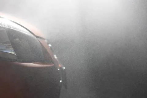 Close-up. Side view. On the headlights and face of the car in shallow patches of Stock Photos