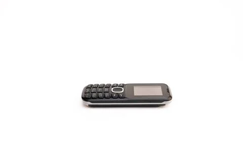 Close-up side view image of a simple push-button telephone on a white backg.. Stock Photos