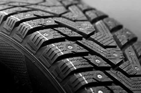 Close-up side view of a large studded tire Stock Photos